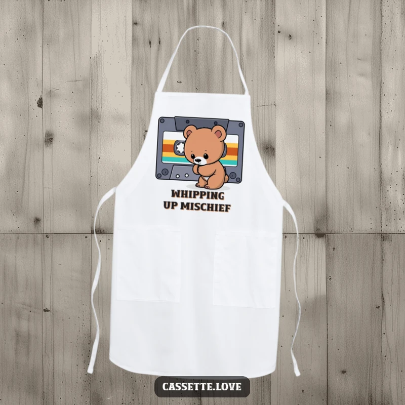 Funny Apron showing a curious bear cub sniffing a giant cassette tape ribbon, perfect for retro music-loving chefs.
