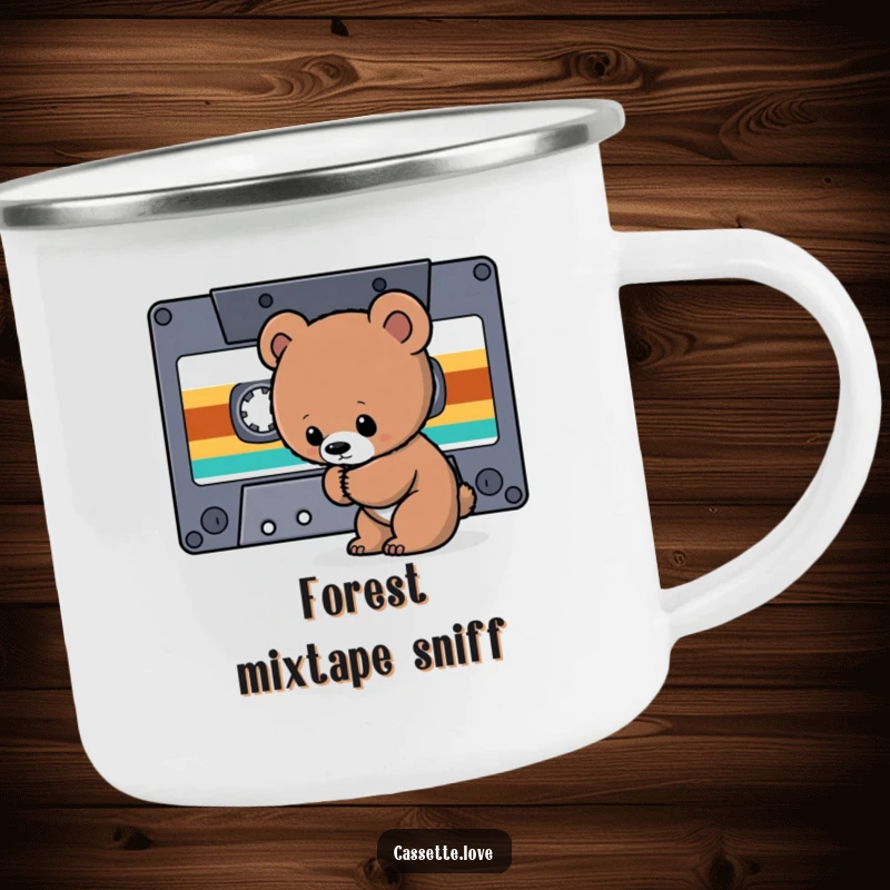 Funny Camping Mug depicting a curious bear cub sniffing a giant cassette tape ribbon, perfect for retro music adventures.