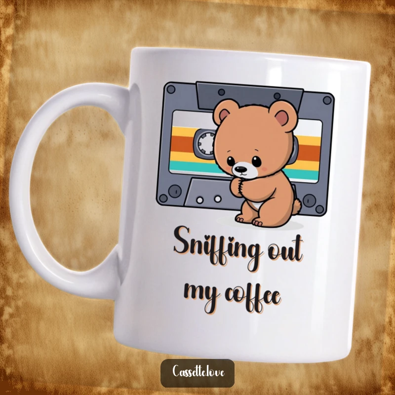 Funny Bear Cub Cassette Mug featuring a curious bear cub sniffing the tape ribbon of a giant retro cassette, exploring music.