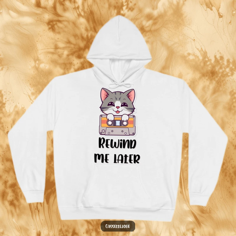 Funny Hoodie showcasing a cheerful cat peeking out of a cassette tape with a playful grin, capturing the essence of retro music enjoyment.