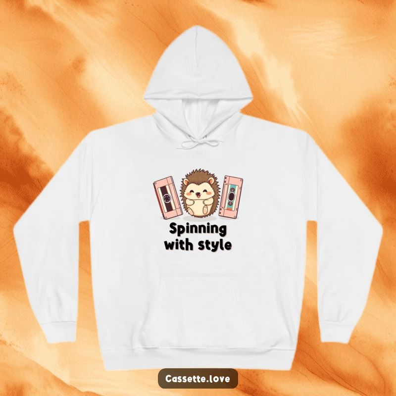 Funny hoodie depicting a happy hedgehog rolling between two oversized, vintage cassette tapes, cozy and charming.