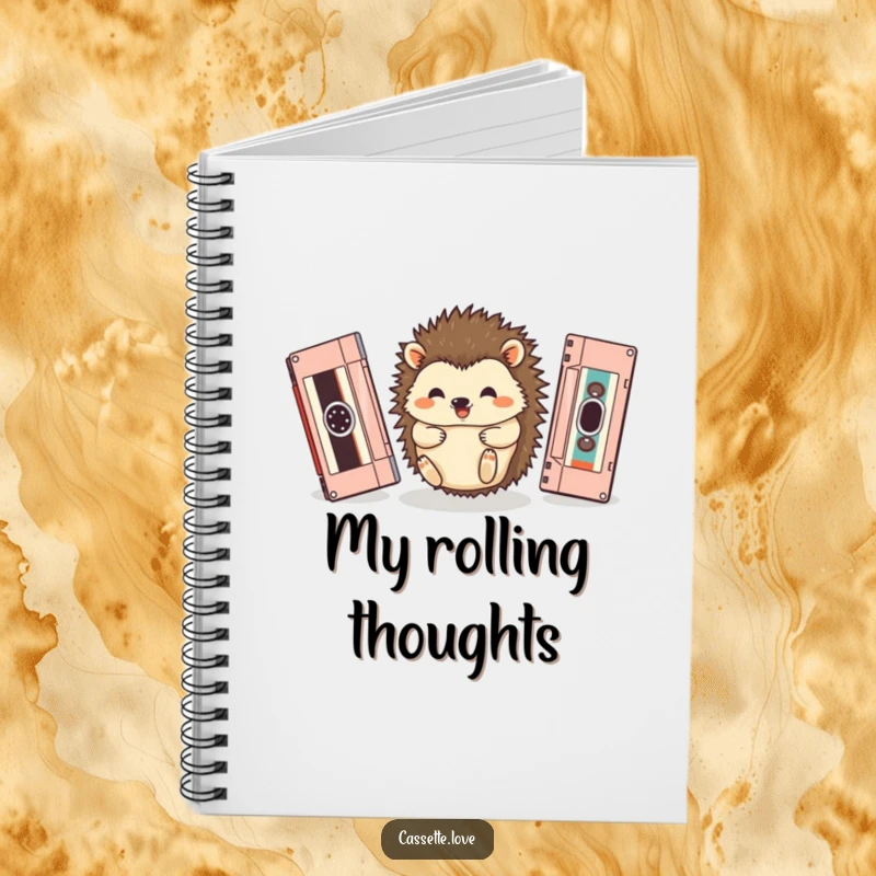 Funny notebook with a happy hedgehog rolling between two vintage cassette tapes, ideal for journaling.