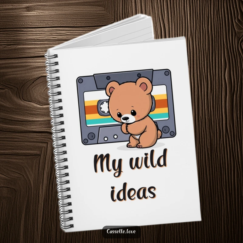 Funny Notebook with a curious bear cub sniffing a giant cassette tape ribbon, perfect for noting retro music discoveries.