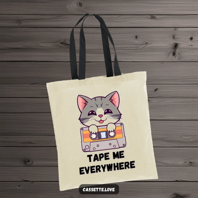 Funny Tote Bag with a cheerful cat peeking from a cassette tape, showing off a playful grin and a love for vintage music.